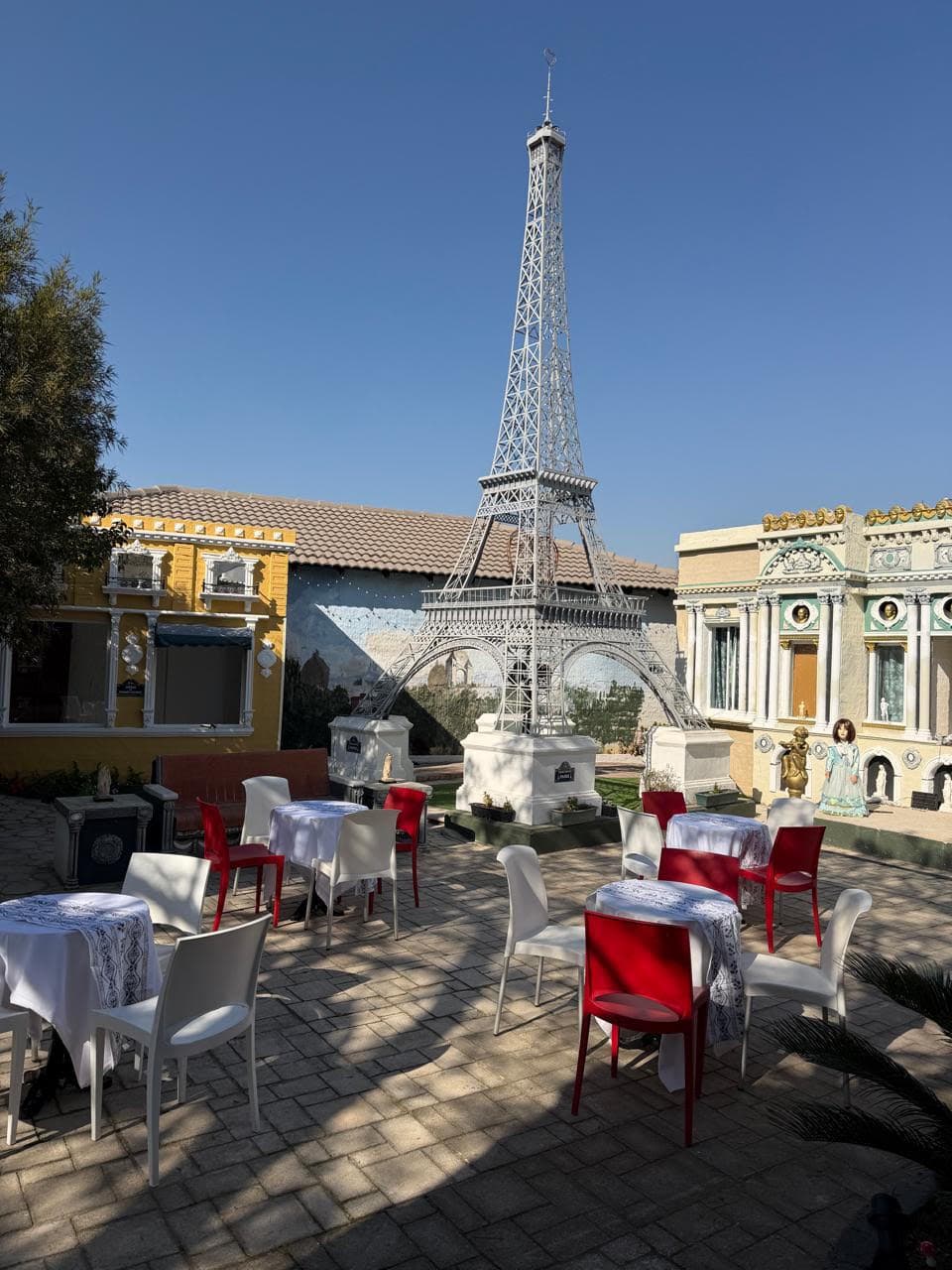 Wiziworld café courtyard with the Eiffel Tower replica and bistro seating
